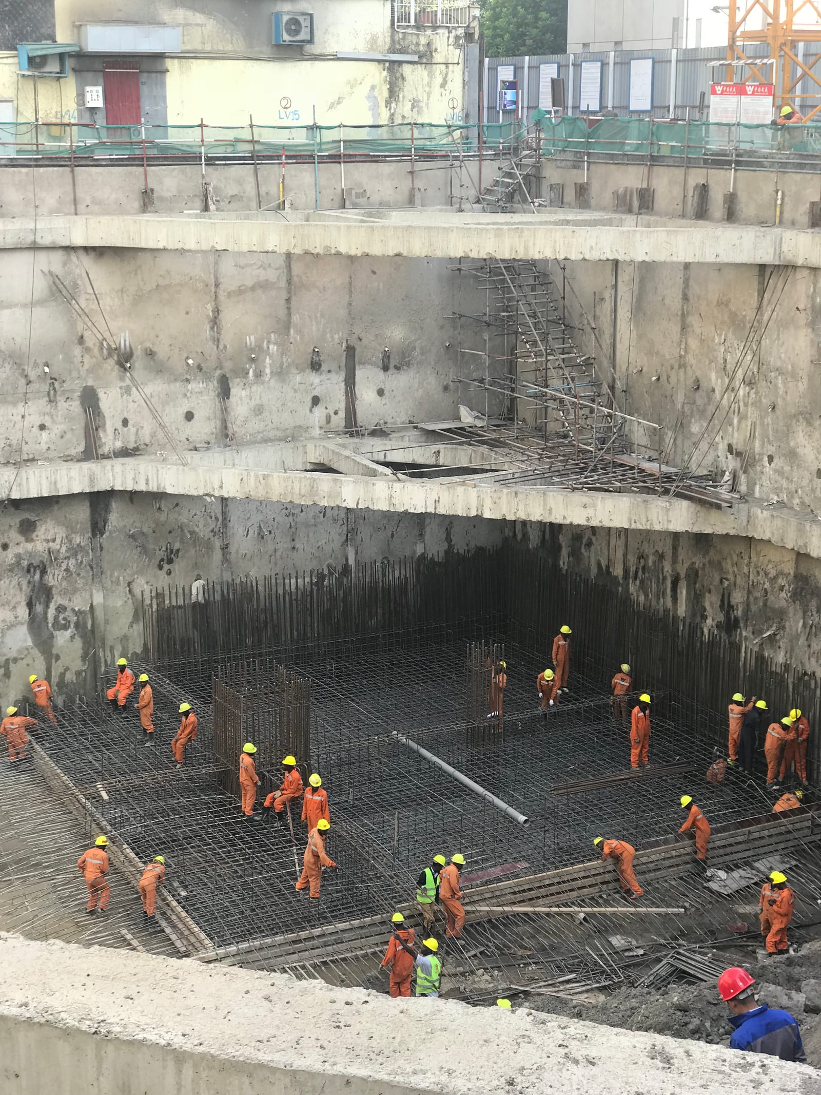 The deep basement excavation for CBK Pension Towers, raft reinforcement being fixed at the base while propped retaining walls hold back the ground beneath neighbouring buildings at the crest