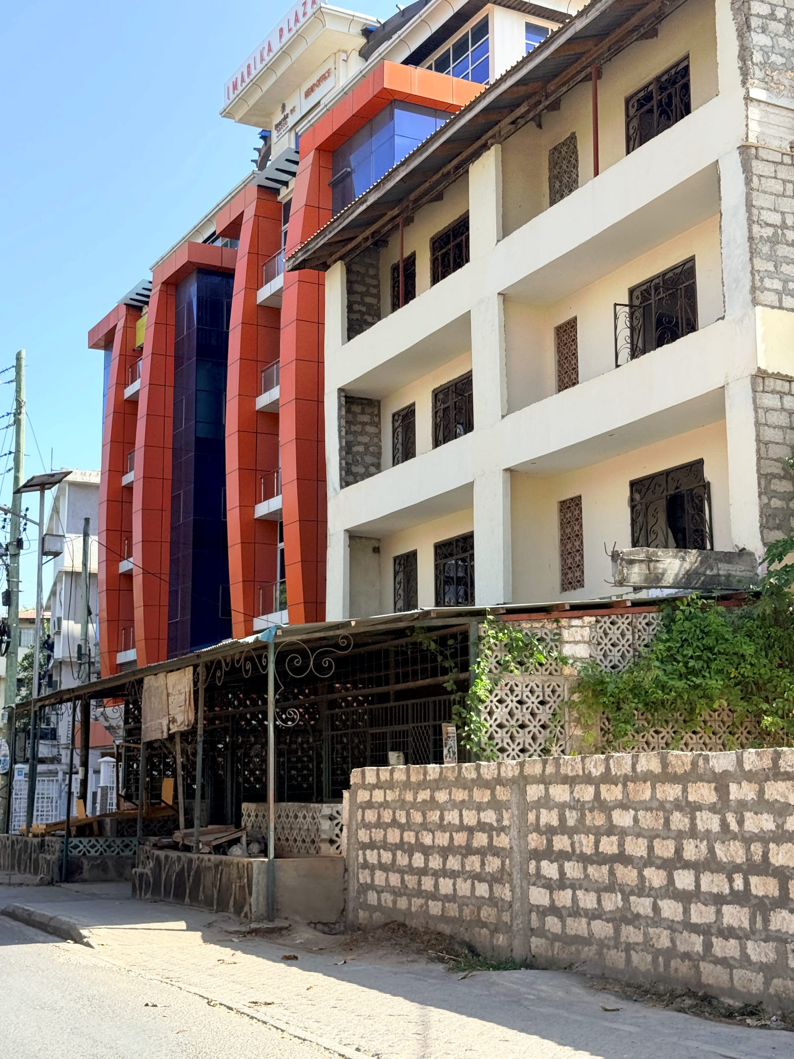 Imarika Plaza in Kilifi, the Imarika Sacco head office, its orange-clad lift core and glazed bays rising over the street frontage